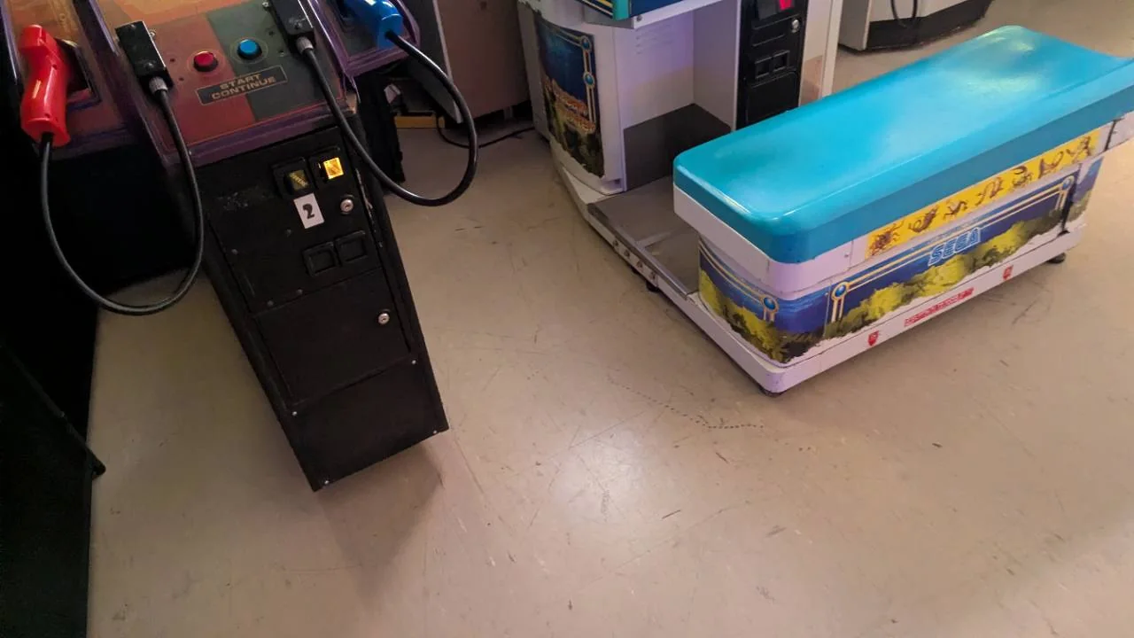 Arcade cabinet controls and themed bench at Pixel Paradise Arcade Angus
