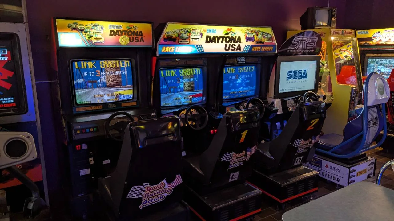 Three linked Daytona USA racing cabinets at Pixel Paradise Angus