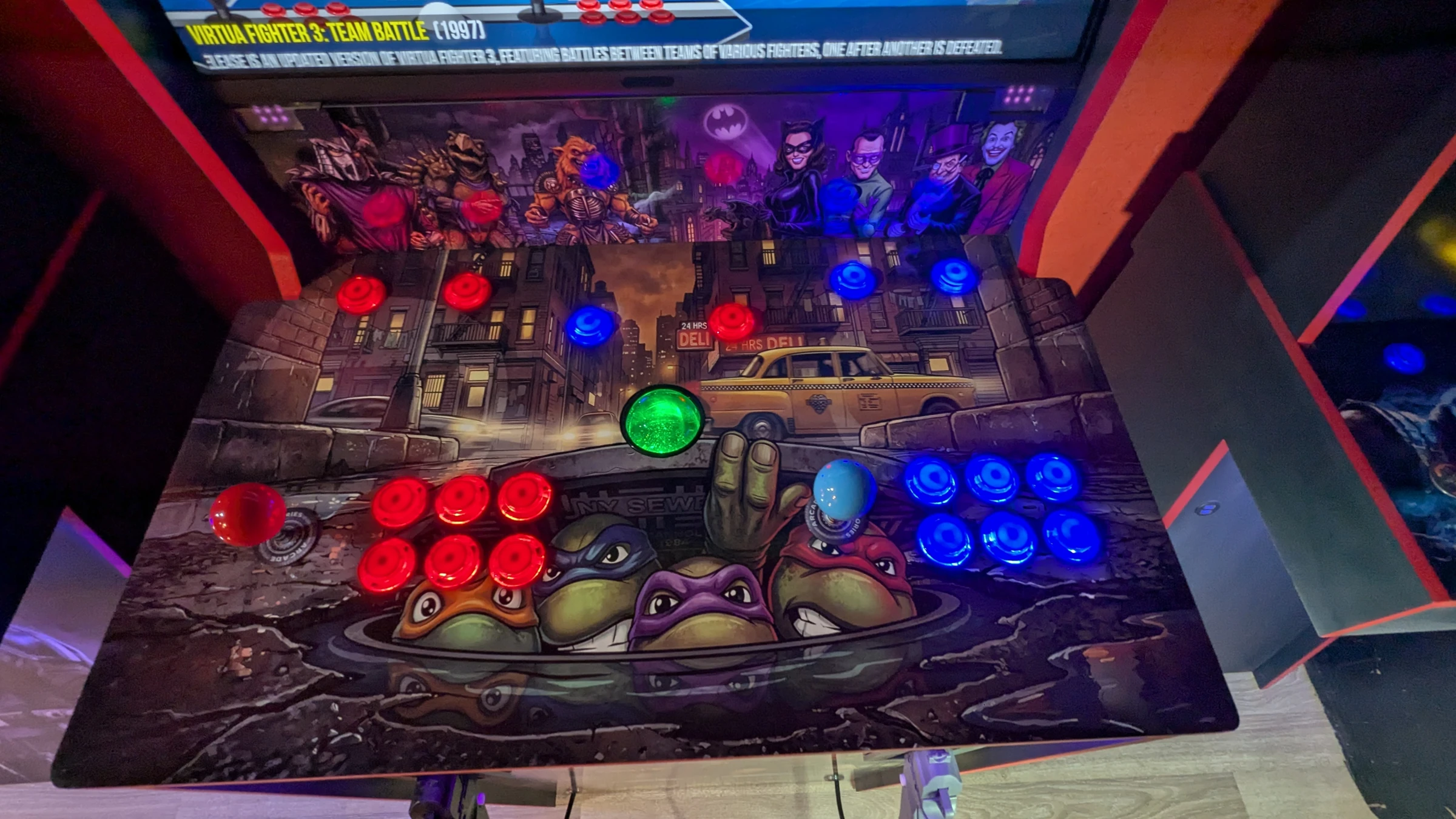 TMNT two-player control deck with red and blue buttons and integrated trackball