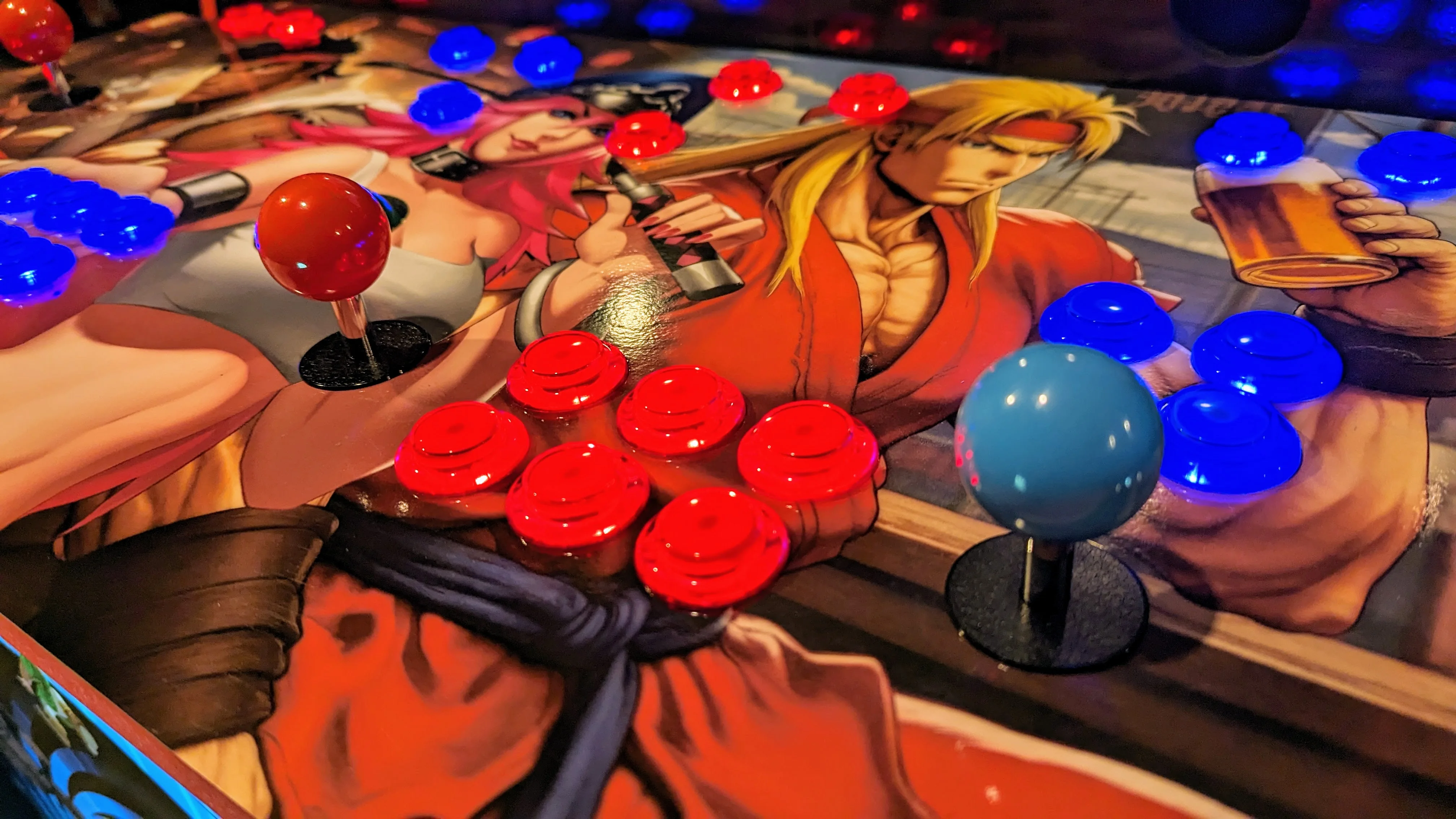 Close-up of illuminated arcade buttons and Street Fighter artwork