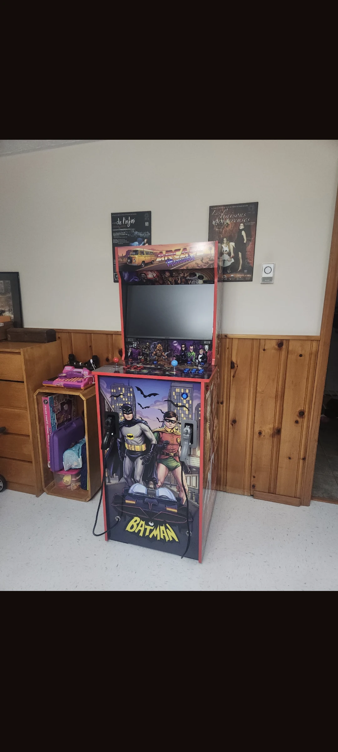 Completed Arcade Memories arcade machine set up at the customer's home, with Batman and Robin artwork and dual light guns
