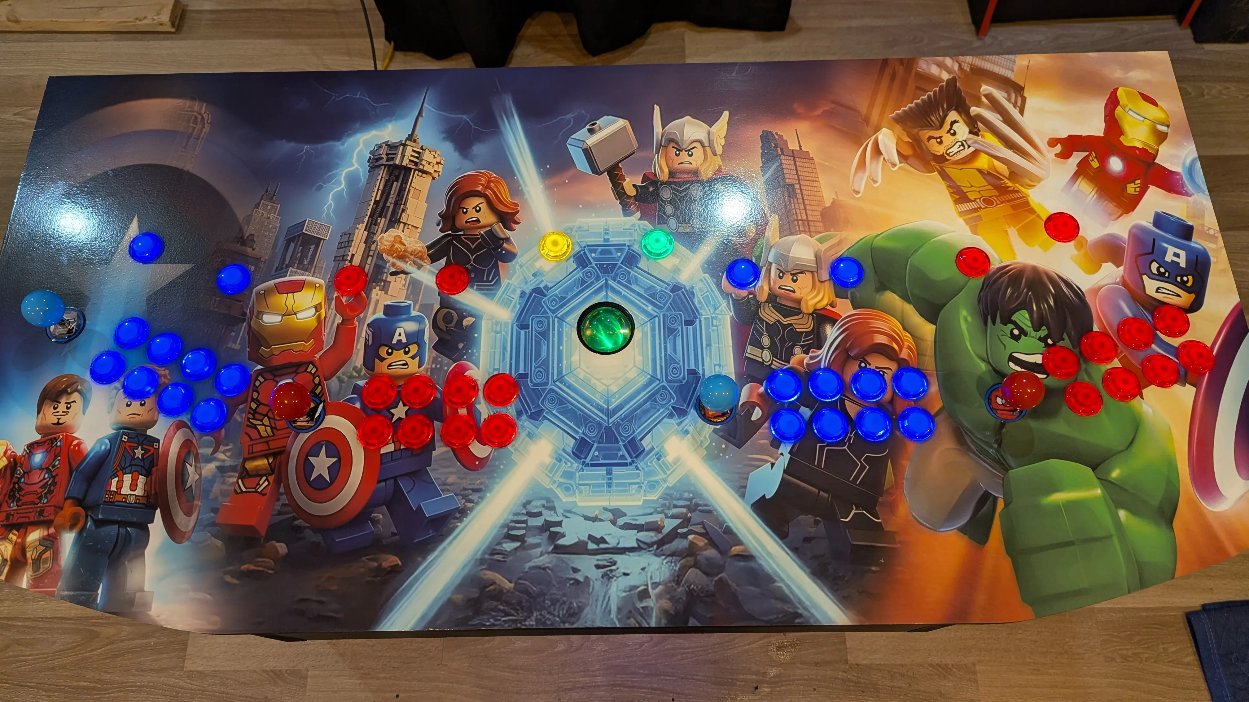 Top view of LEGO Marvel Avengers arcade control panel with lit joysticks and buttons