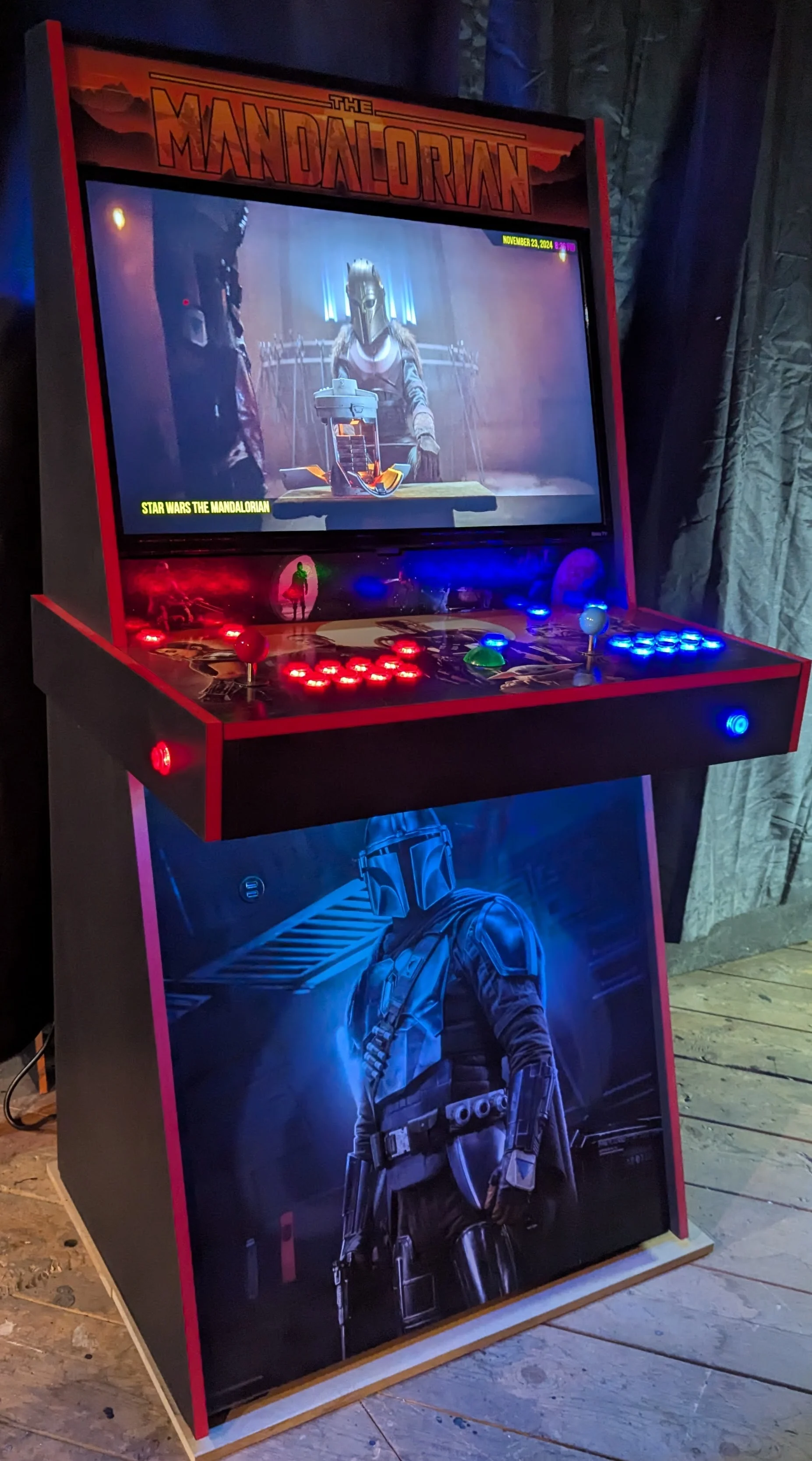 Angled front view of the Mandalorian arcade machine with illuminated controls