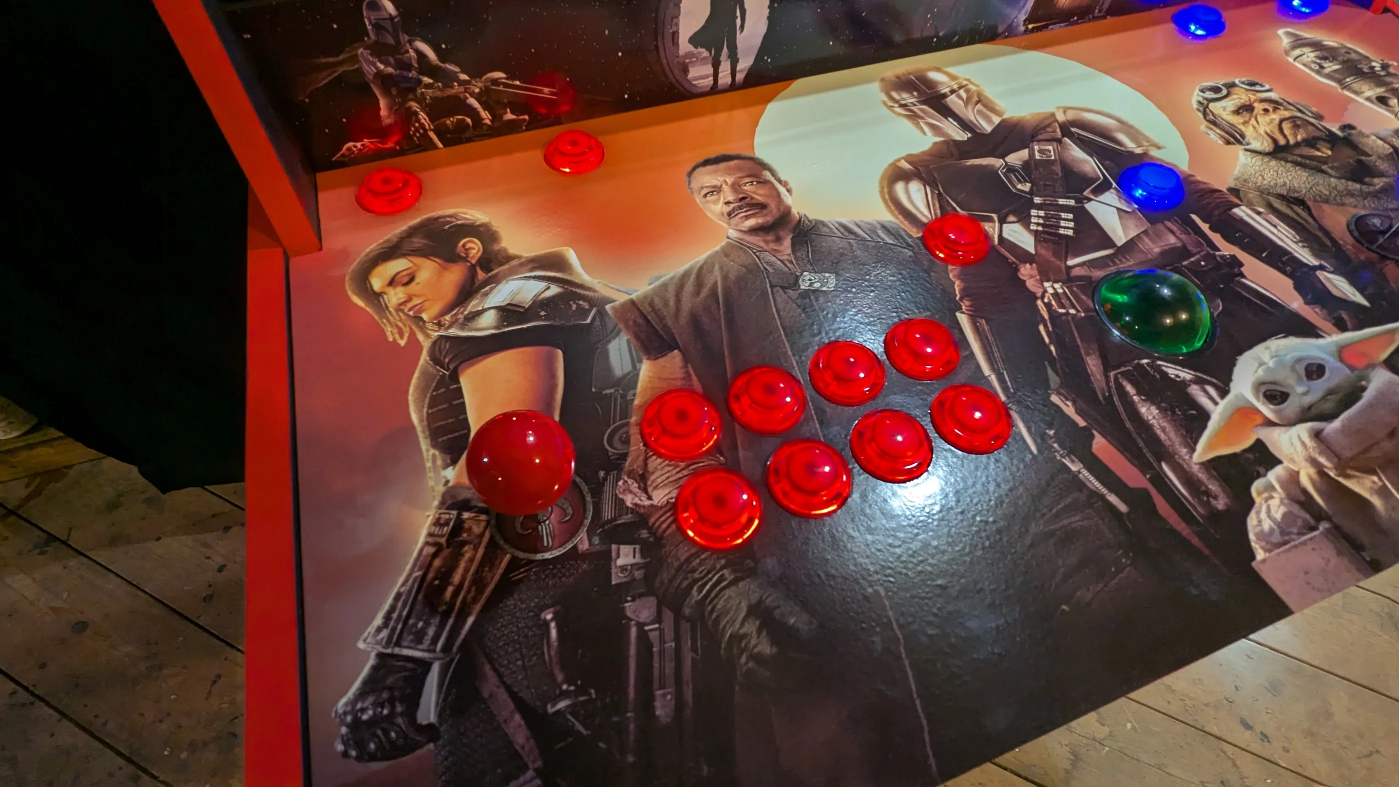 Red illuminated player controls on the Mandalorian arcade machine