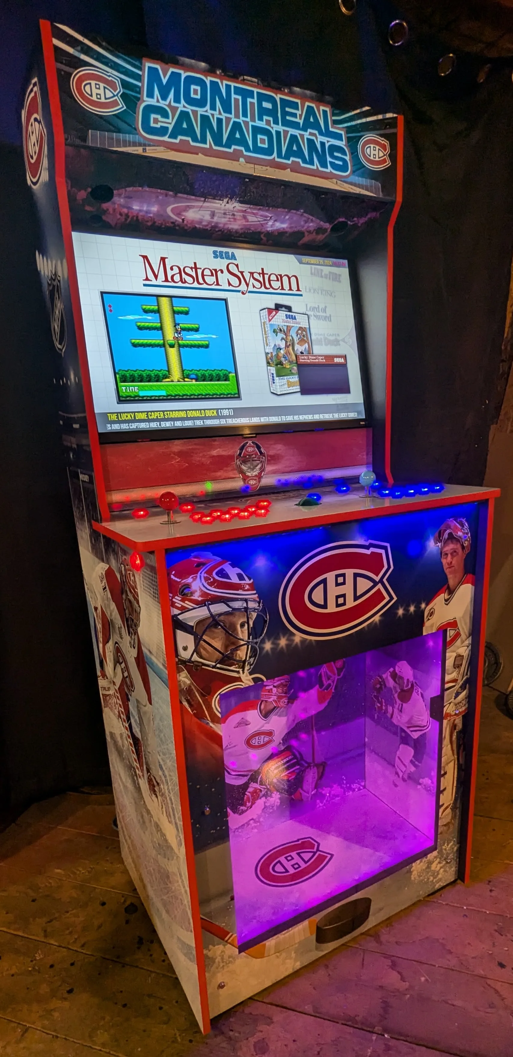 Angled front view of the Montreal Canadiens arcade machine with illuminated controls