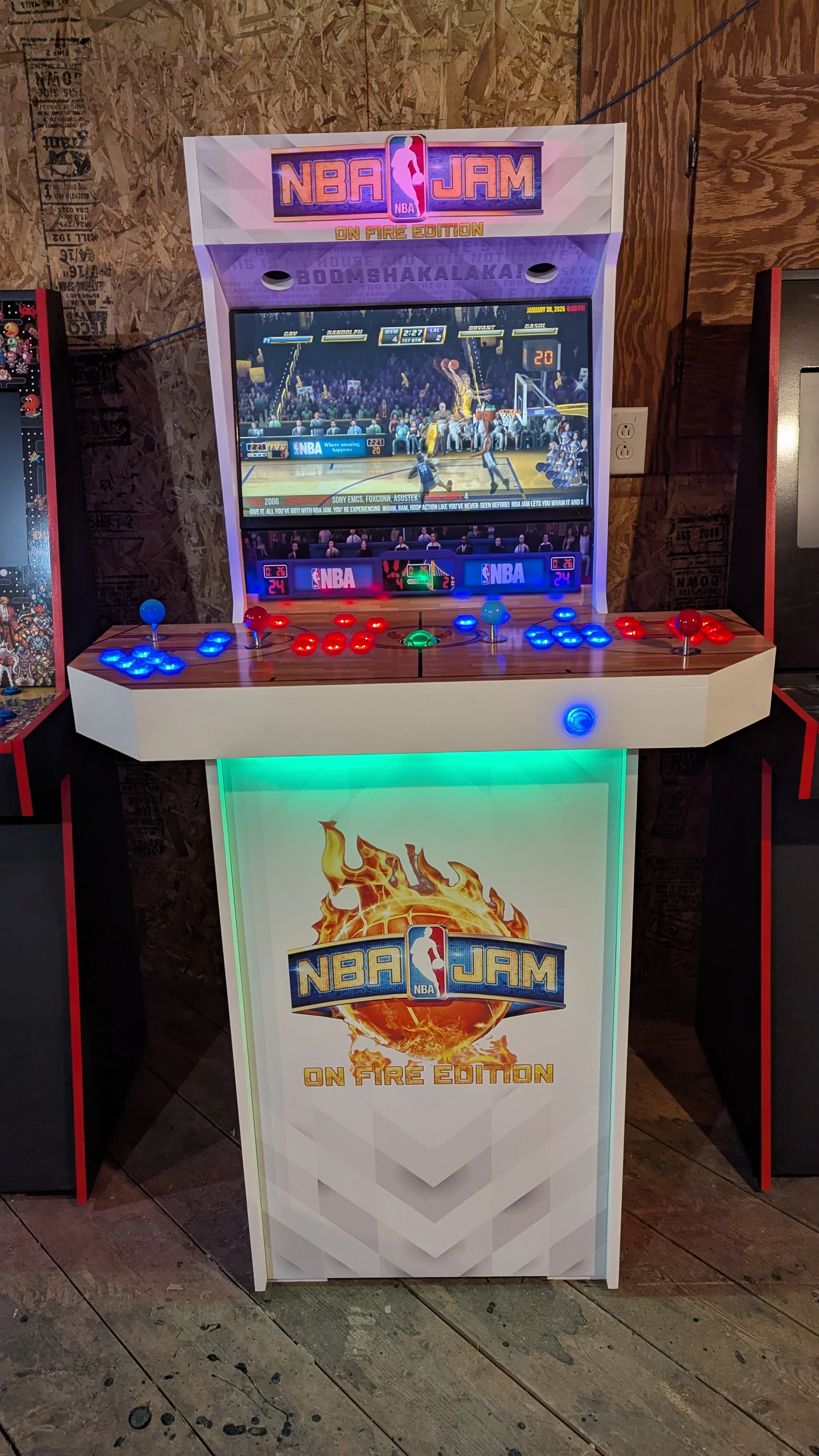 Front cabinet view with green illuminated front panel and red and blue controls