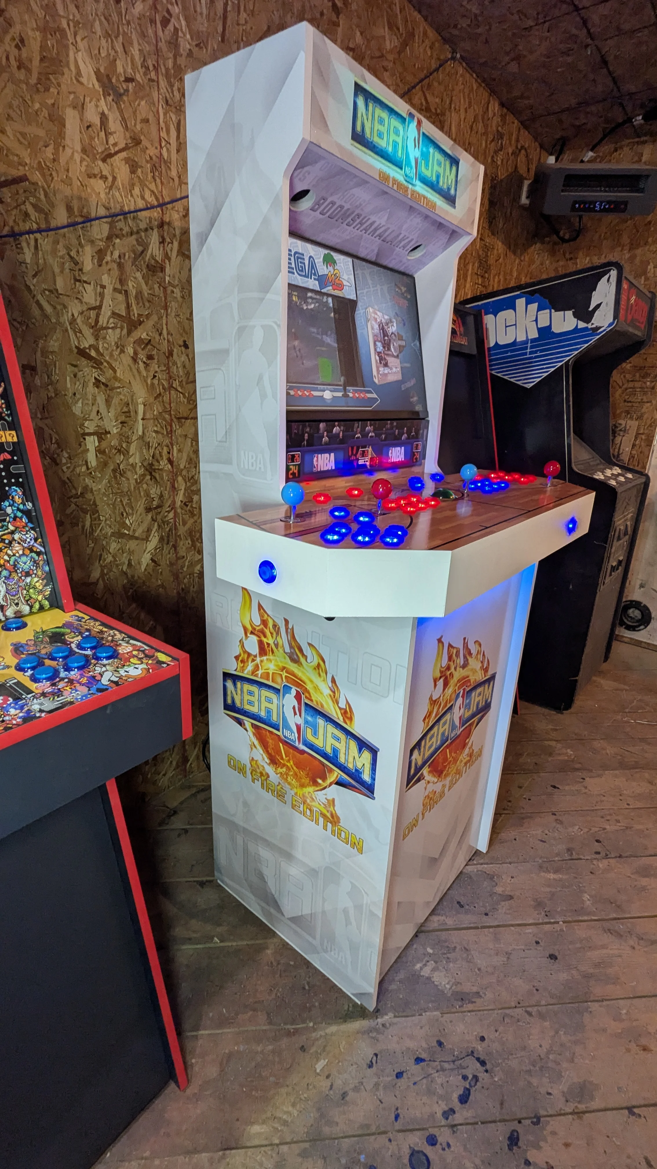 Right angle showing the NBA Jam cabinet and four-player controls