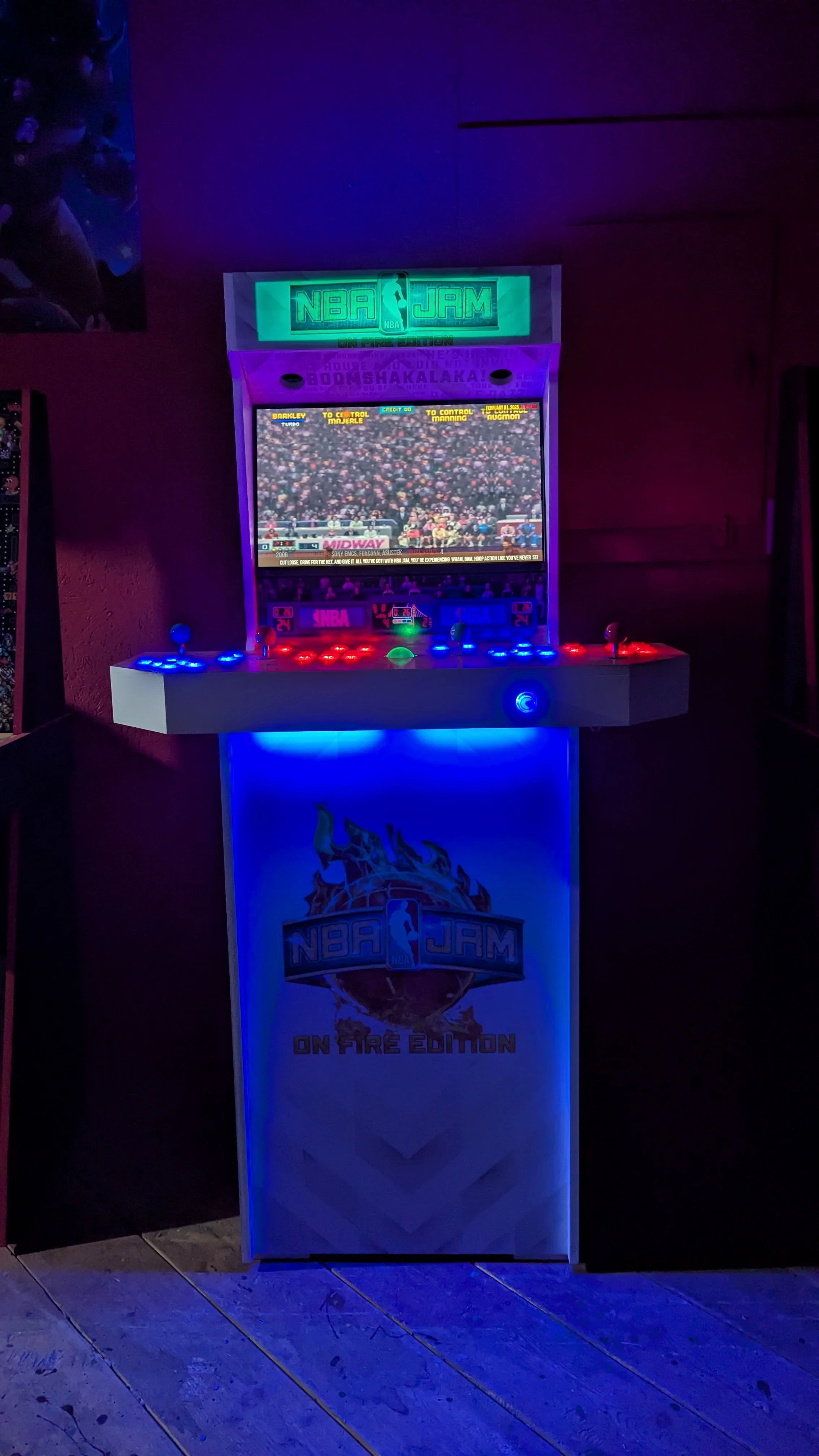 NBA Jam cabinet glowing blue in the dark while running an arcade game