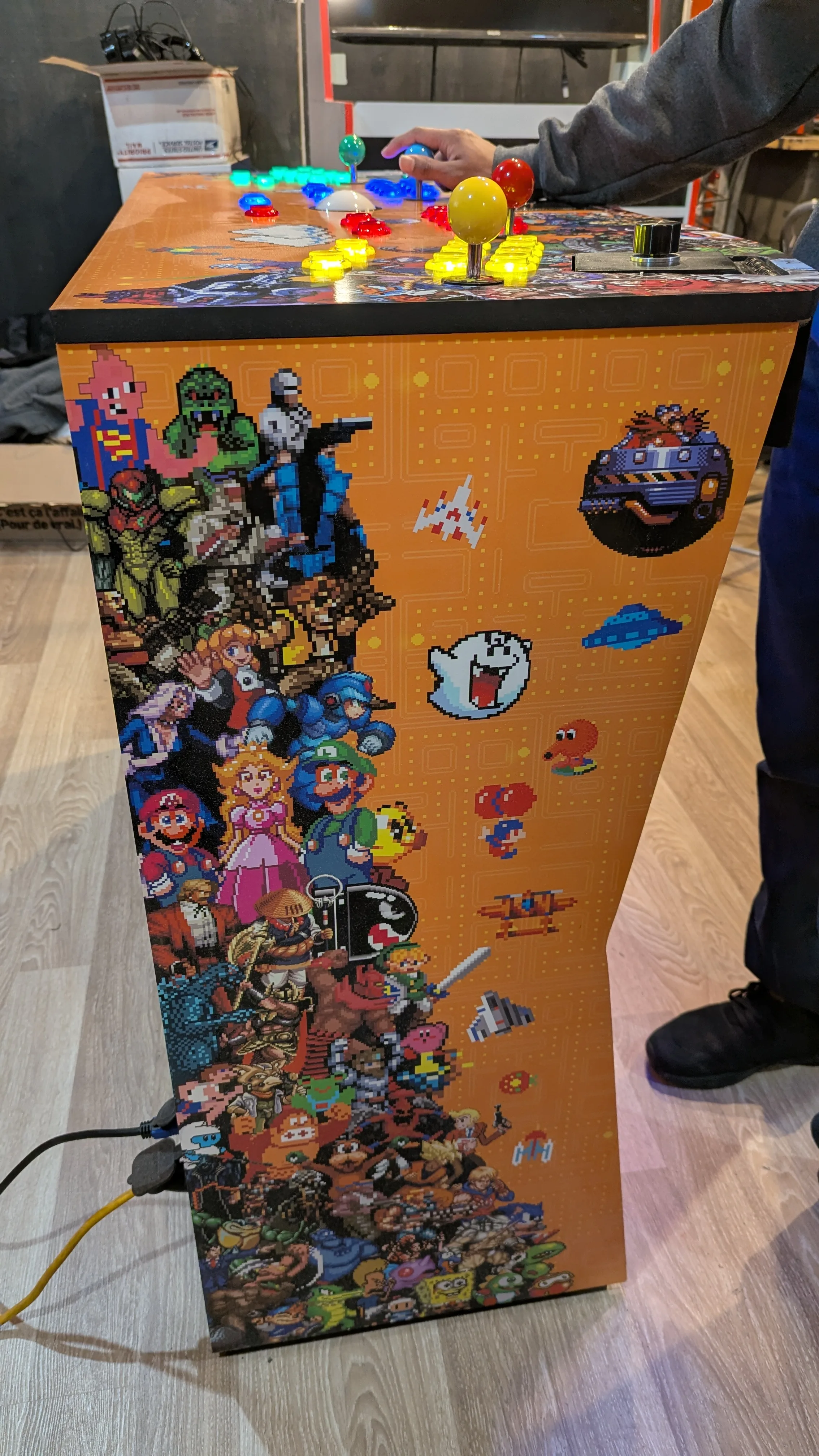 Pedestal arcade machine side view showing cabinet artwork and side controls