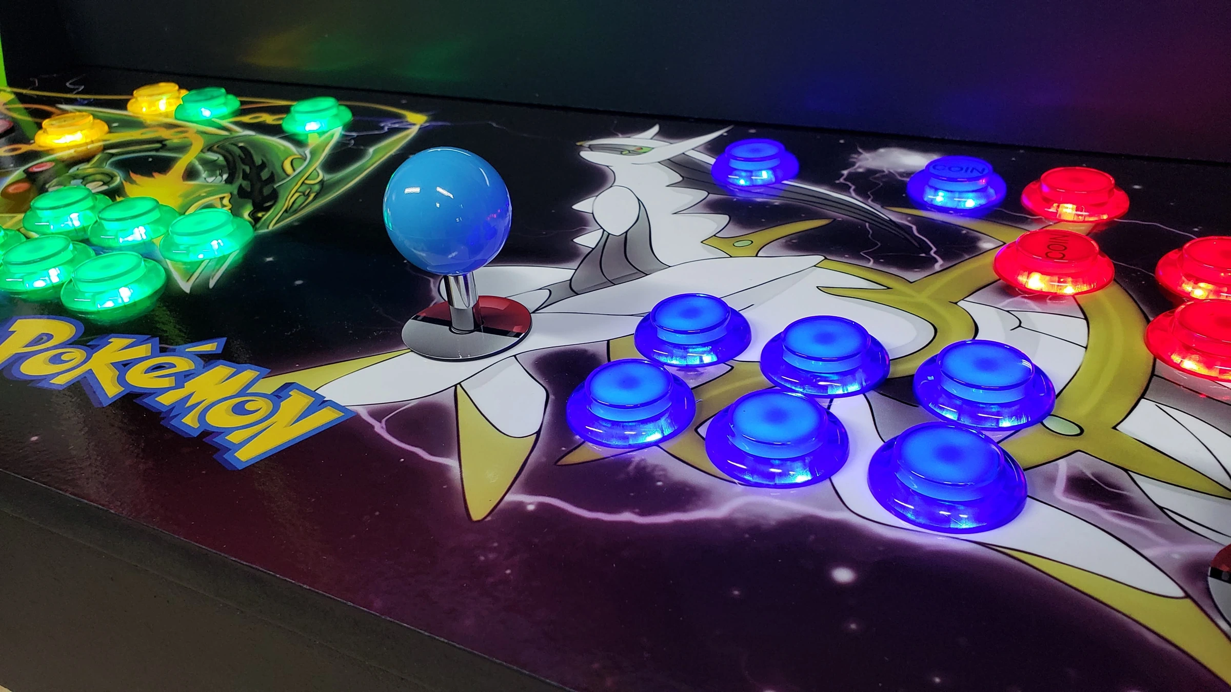 Close-up of blue and red LED controls over Arceus artwork