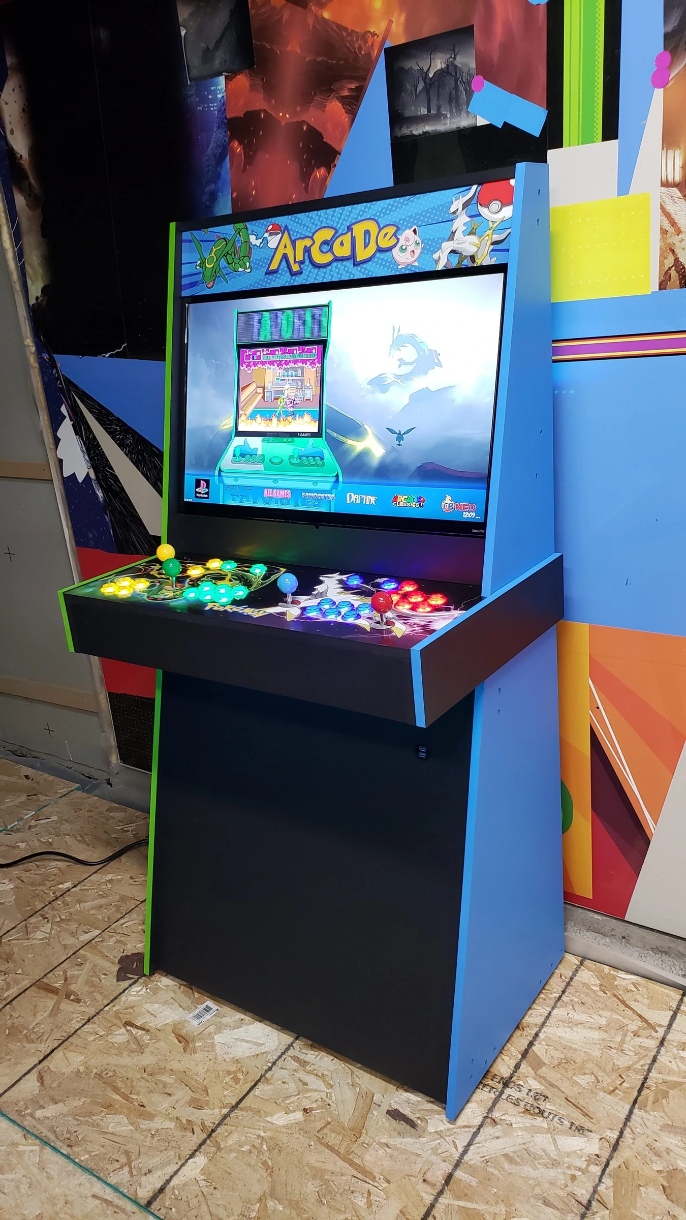Angled view of the Pokémon Go Big or Go Home arcade showing its blue side and illuminated four-player controls
