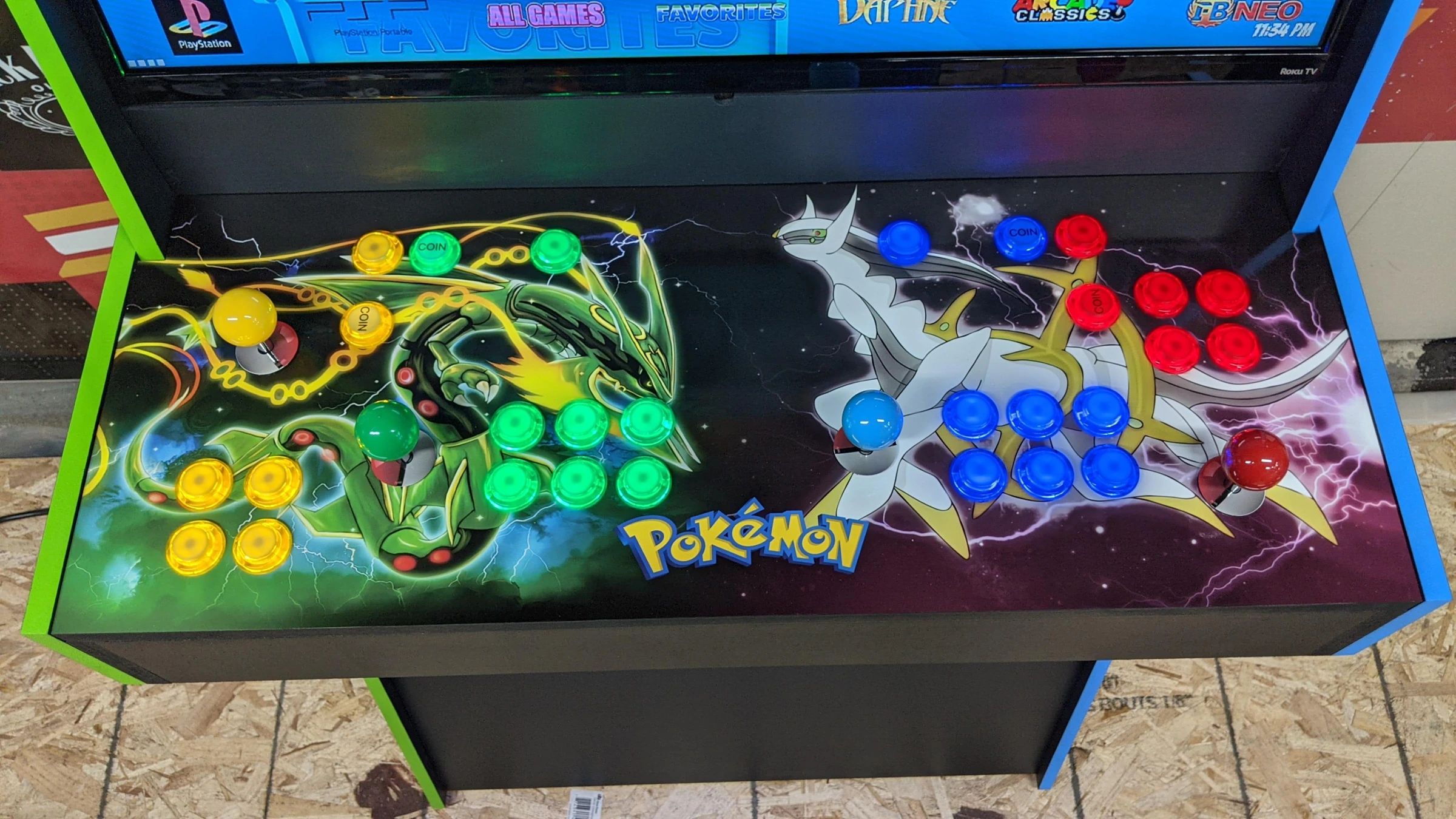 Full four-player control deck with Rayquaza and Arceus artwork and yellow, green, blue and red controls