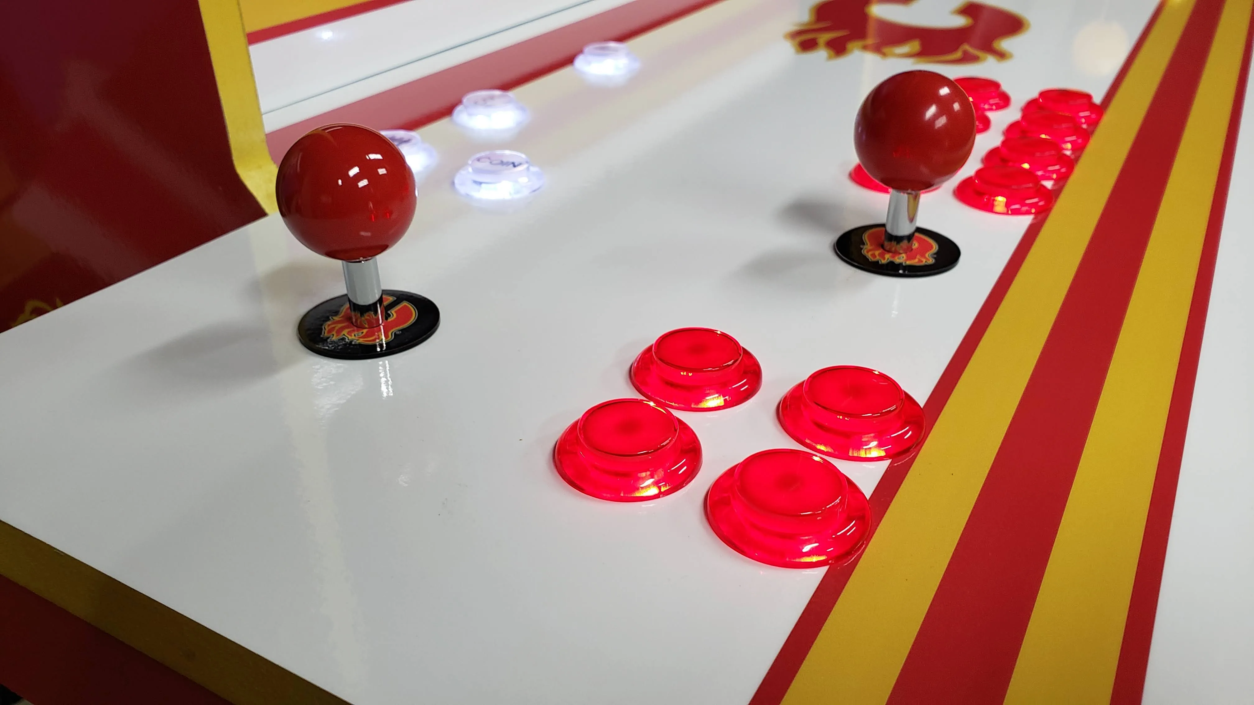 Close-up of red joysticks and LED buttons on the Flames control deck