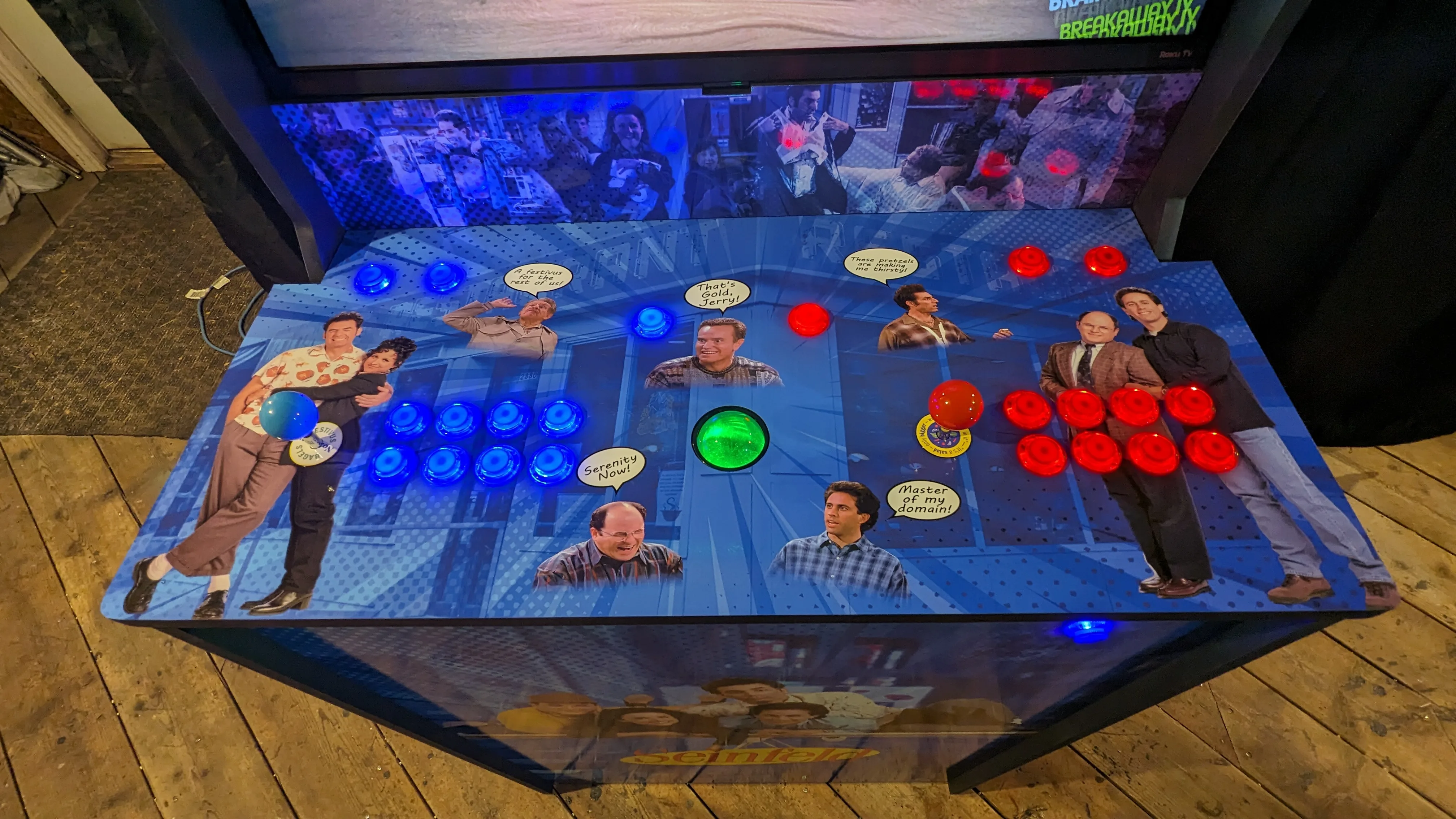 Seinfeld arcade control panel with illuminated buttons, joysticks, and colour-changing trackball