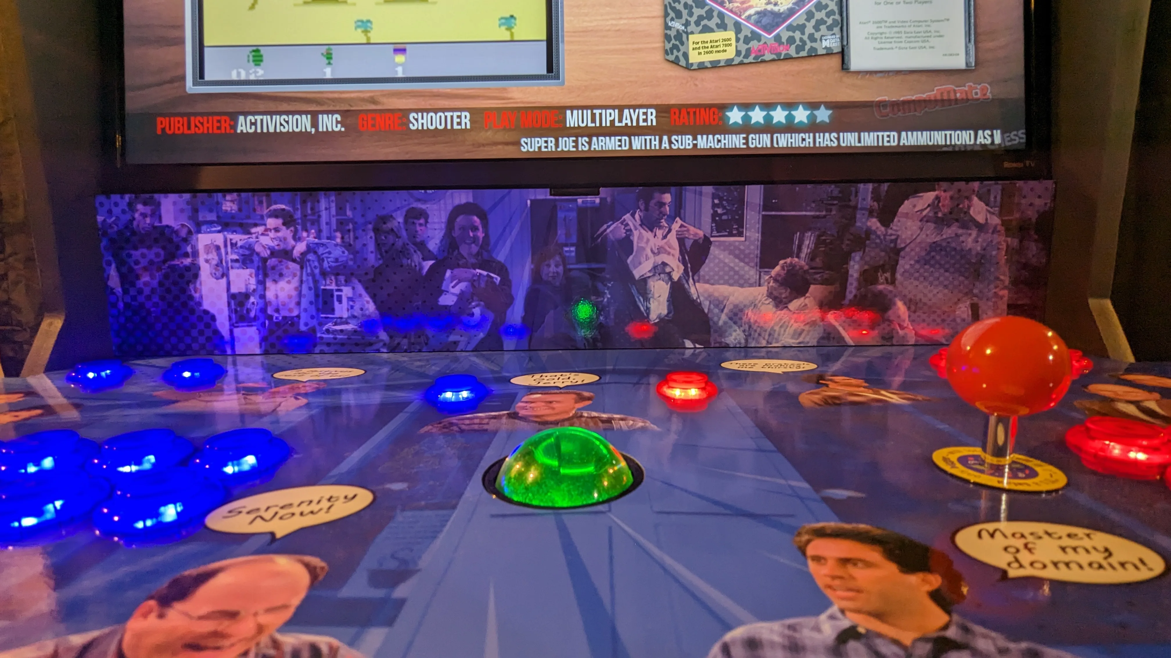 Close-up of the Seinfeld arcade control panel and illuminated lower screen artwork