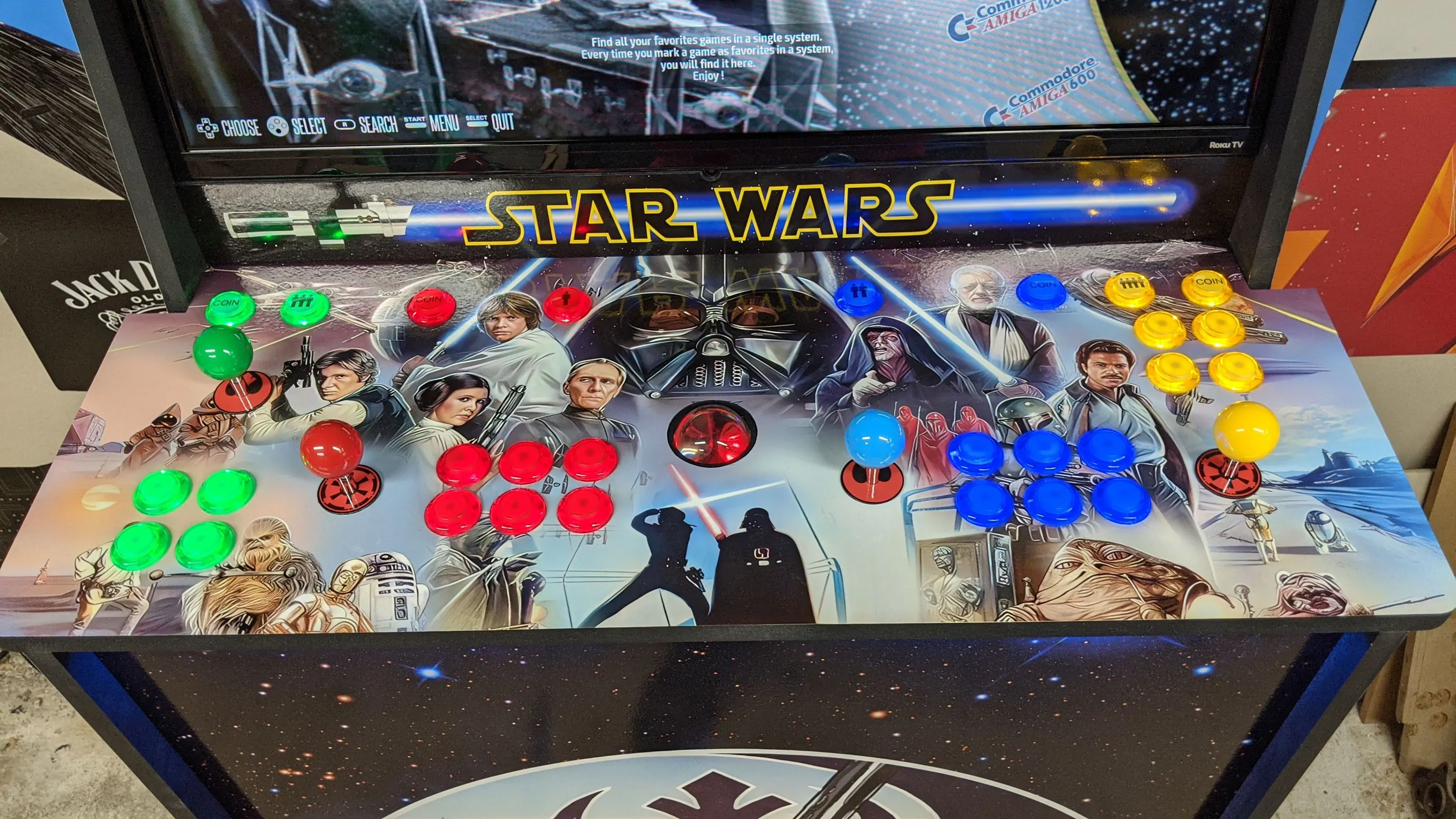 Four-player Star Wars control deck with illuminated buttons and a central trackball