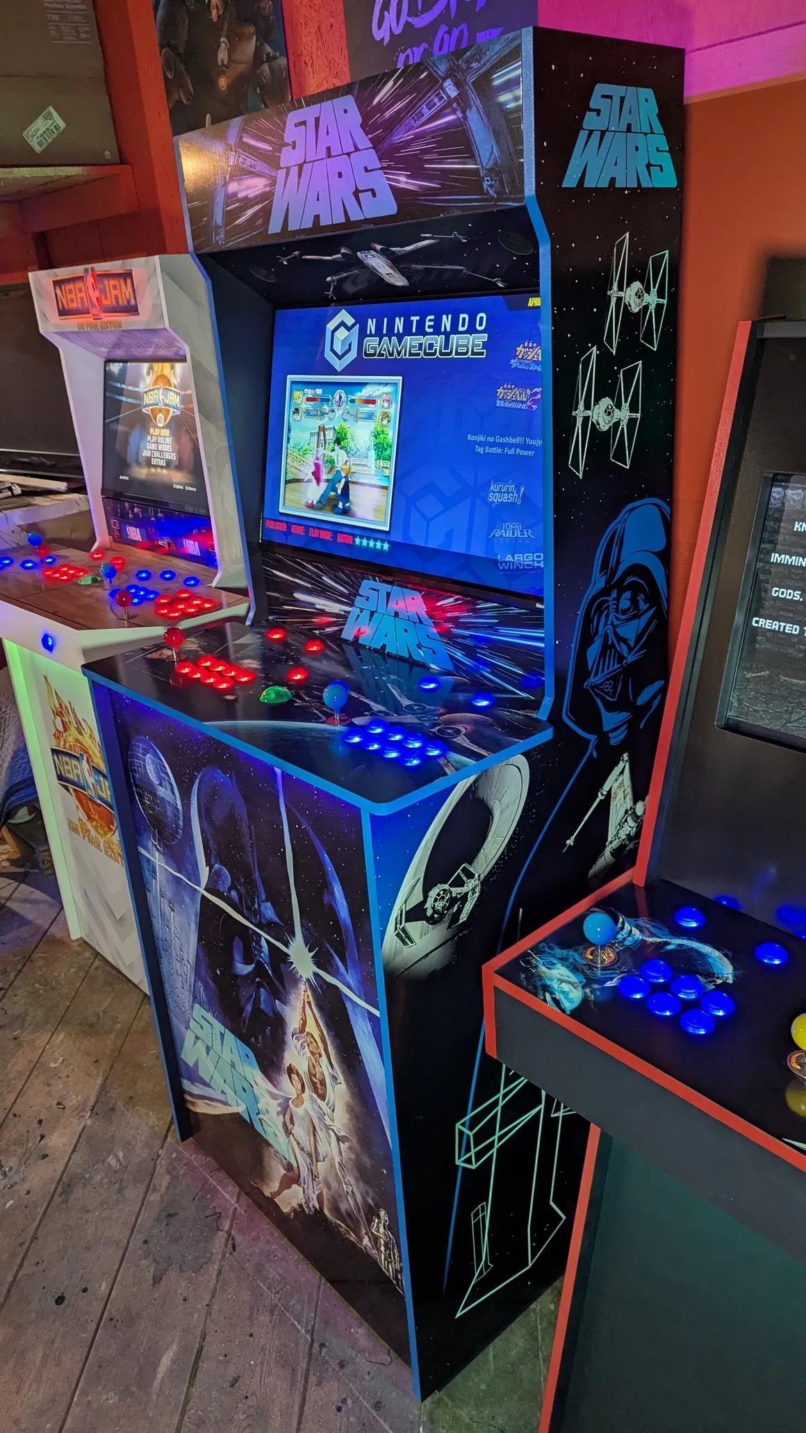 Star Wars arcade machine control deck with glowing buttons and themed cabinet artwork