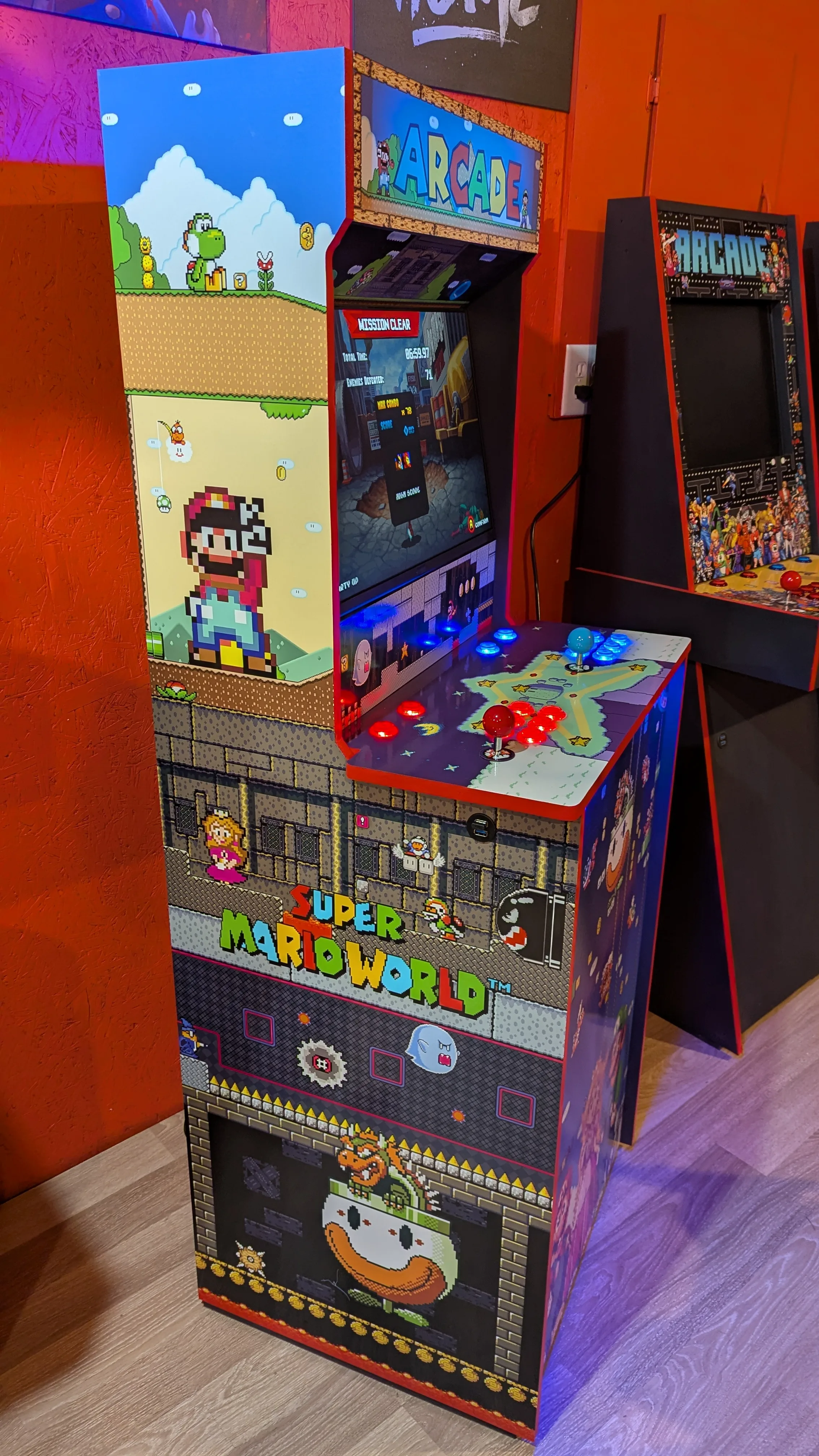 Super Mario World arcade machine side artwork with lit controls and full cabinet view